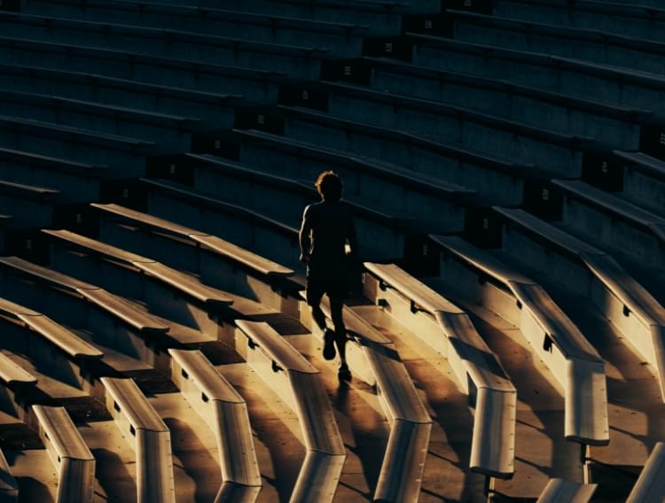 Runner climbing stadium stairs